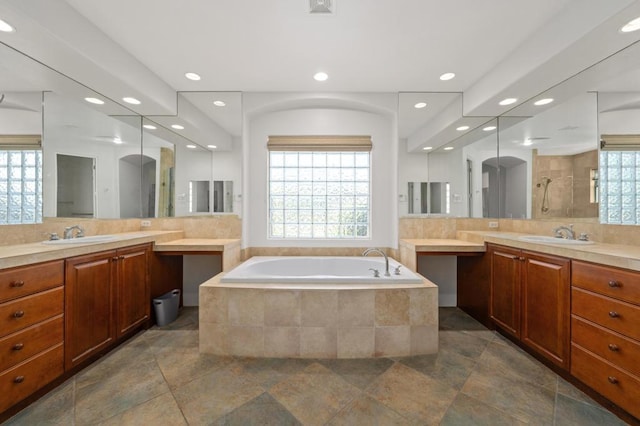 bathroom with vanity, separate shower and tub, and backsplash