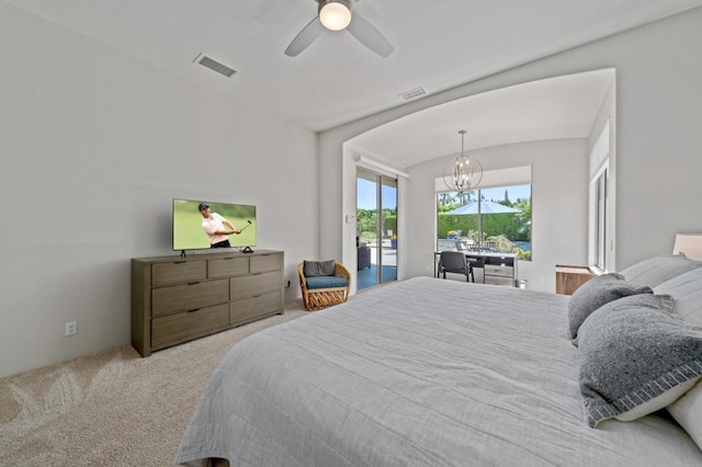 bedroom featuring light carpet, access to exterior, and ceiling fan with notable chandelier