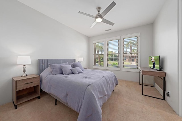 bedroom with ceiling fan, light colored carpet, and lofted ceiling