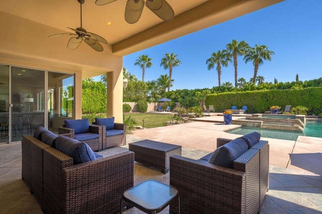 view of patio featuring ceiling fan, a swimming pool with hot tub, and an outdoor hangout area