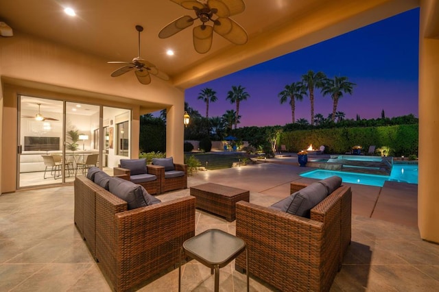 patio terrace at dusk with outdoor lounge area and ceiling fan