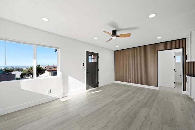 interior space featuring ceiling fan and light wood-type flooring