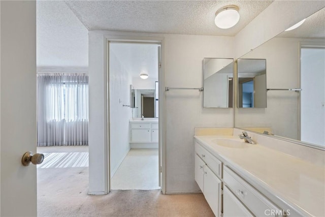 bathroom featuring a textured ceiling and vanity