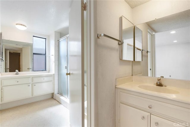 full bathroom with a shower stall, vanity, and recessed lighting