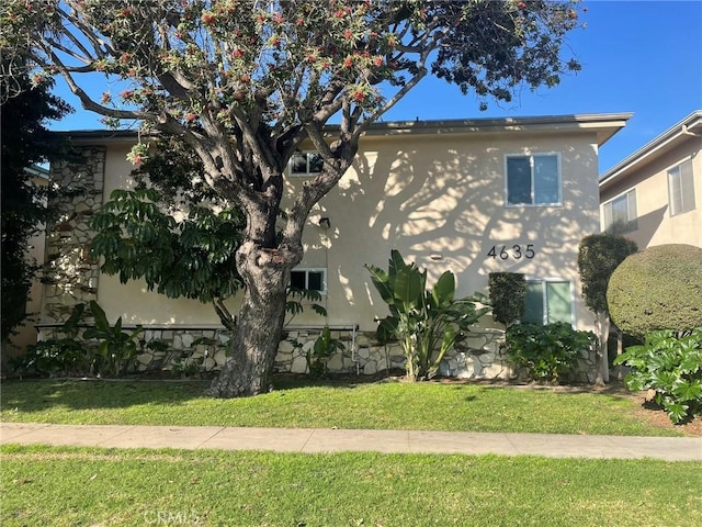 view of side of property with a lawn