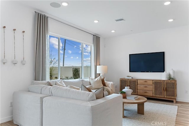 living room with light hardwood / wood-style flooring