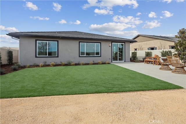 rear view of property featuring a yard and a patio