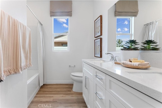 full bathroom with vanity, wood-type flooring, toilet, and shower / bathtub combination with curtain