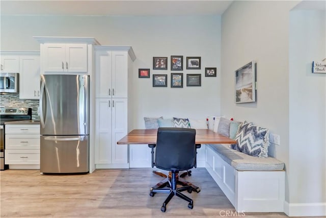 office featuring light hardwood / wood-style flooring and breakfast area