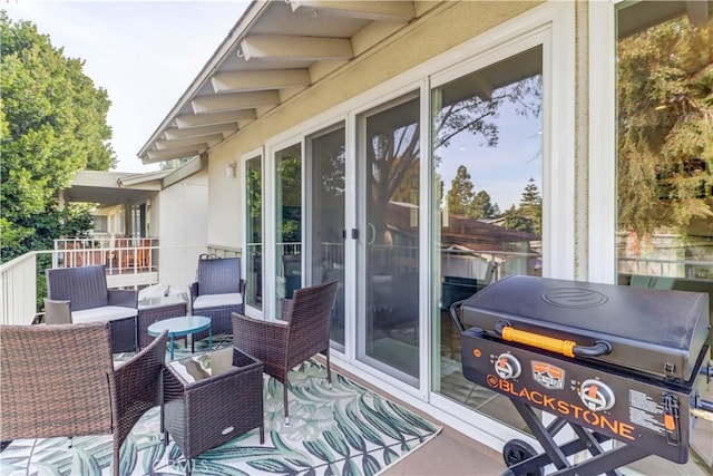 view of patio featuring a balcony and outdoor lounge area