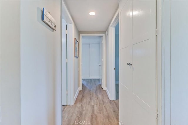 corridor with light hardwood / wood-style flooring