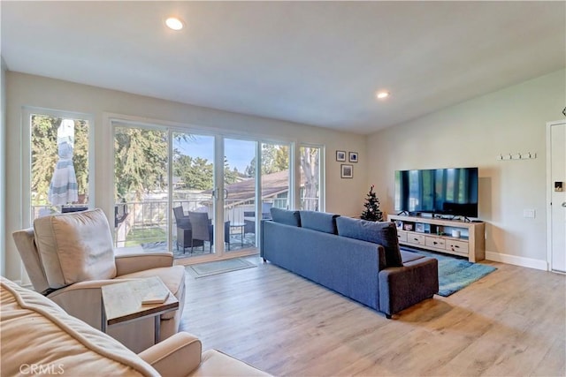 living room with lofted ceiling and light wood-type flooring