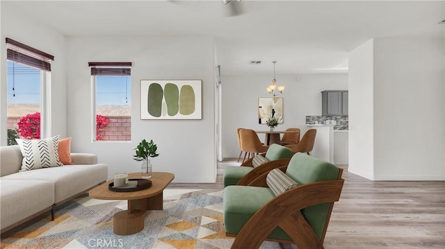 sitting room with visible vents, a notable chandelier, and light wood-style flooring