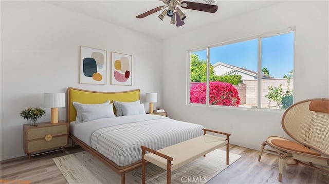 bedroom featuring light wood-type flooring and ceiling fan