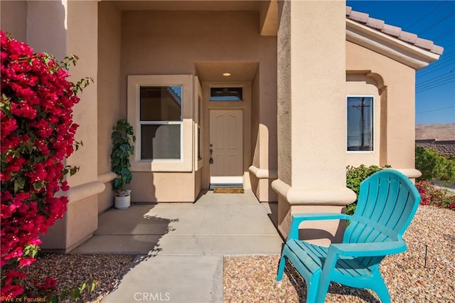 entrance to property with stucco siding