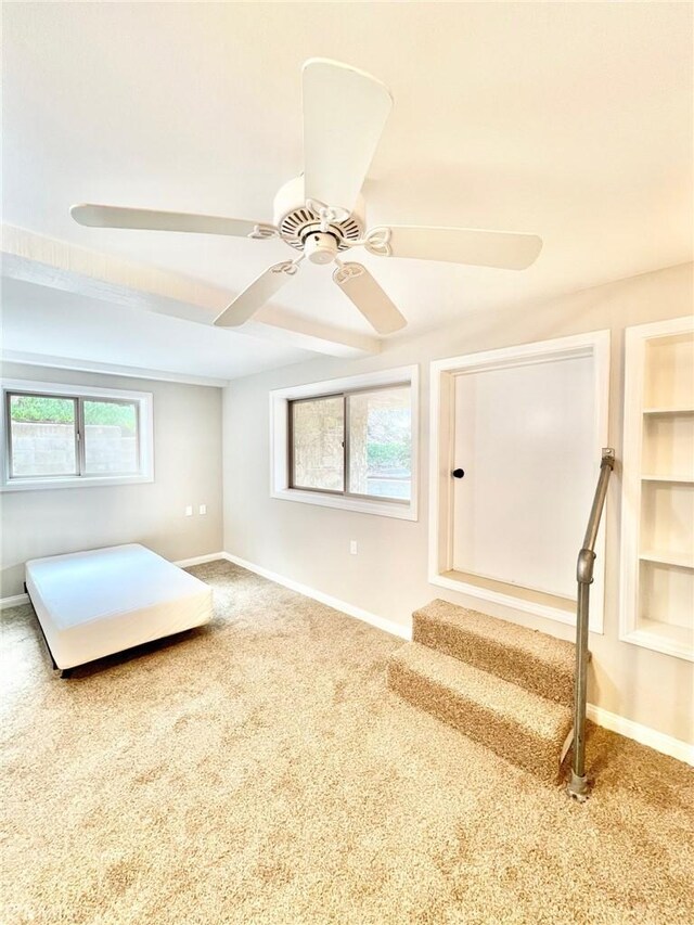 interior space featuring carpet floors and ceiling fan