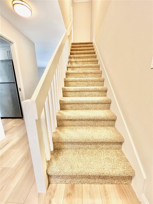 staircase with wood-type flooring