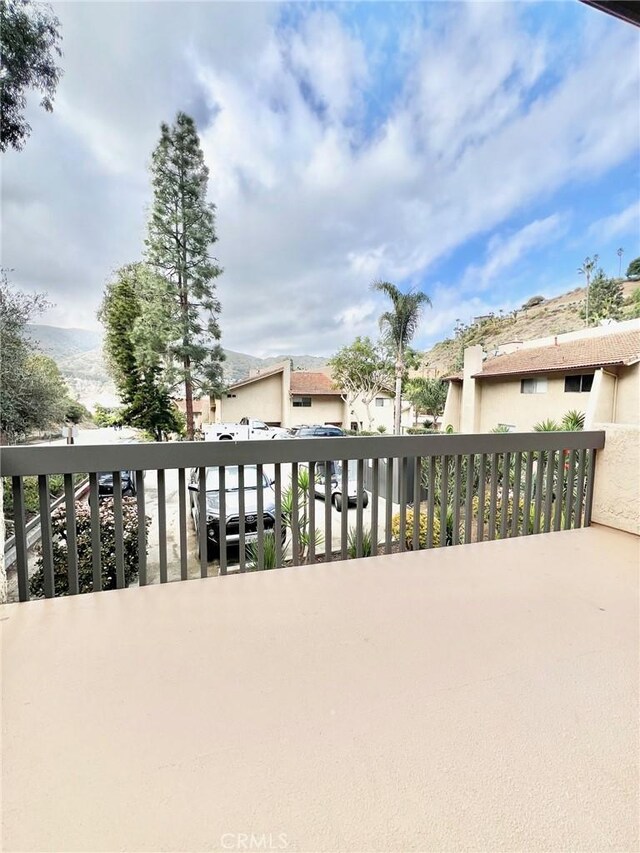 view of patio featuring a balcony