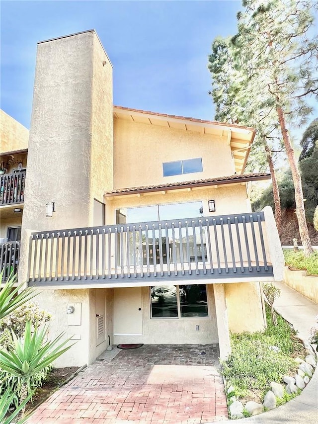 rear view of house featuring a balcony