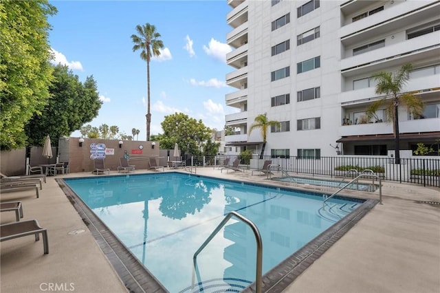 view of pool featuring a patio and a community hot tub