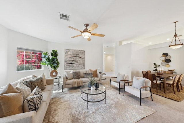 living room featuring light colored carpet and ceiling fan