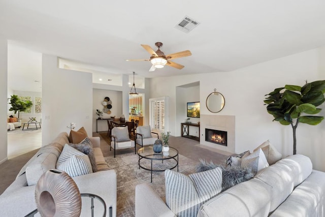 carpeted living room with ceiling fan