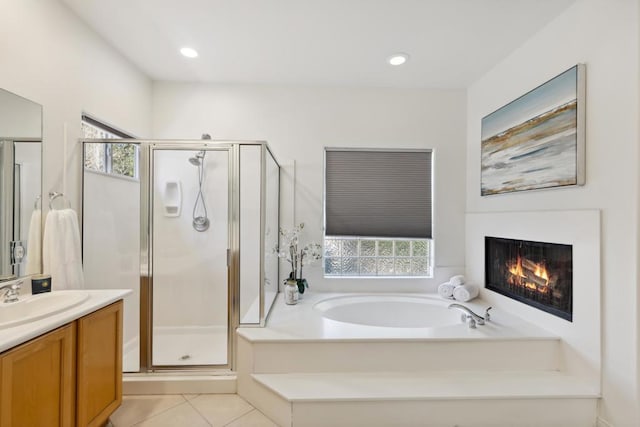 bathroom with independent shower and bath, vanity, plenty of natural light, and tile patterned flooring