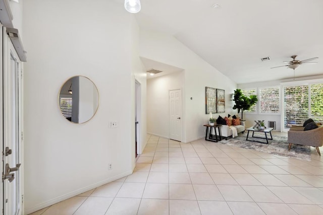 foyer entrance featuring high vaulted ceiling, light tile patterned floors, and ceiling fan