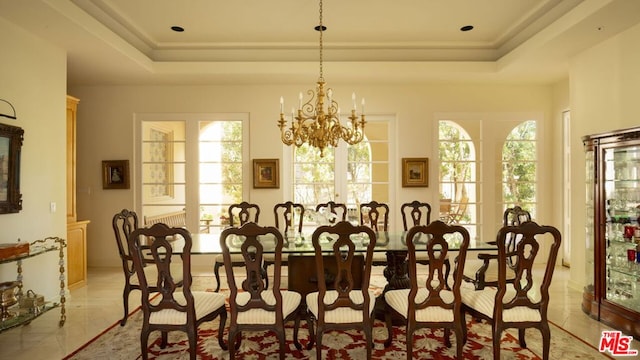 dining room featuring a chandelier and a tray ceiling