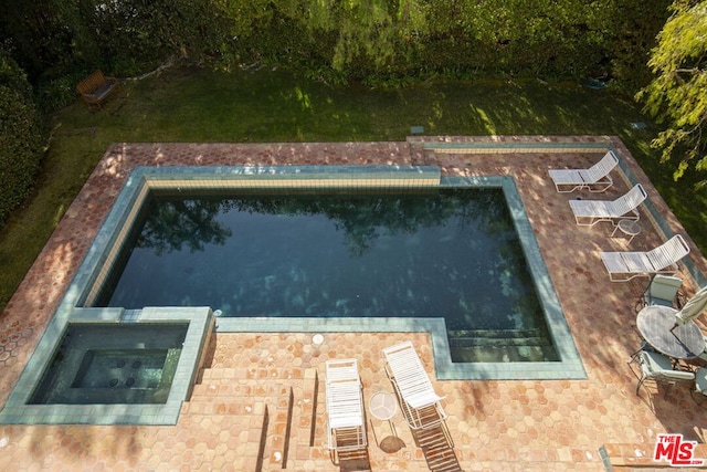 view of swimming pool with an in ground hot tub