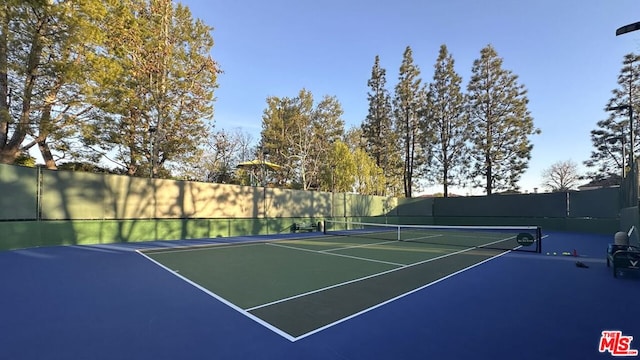 view of tennis court with basketball hoop