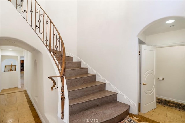 stairway featuring tile patterned flooring