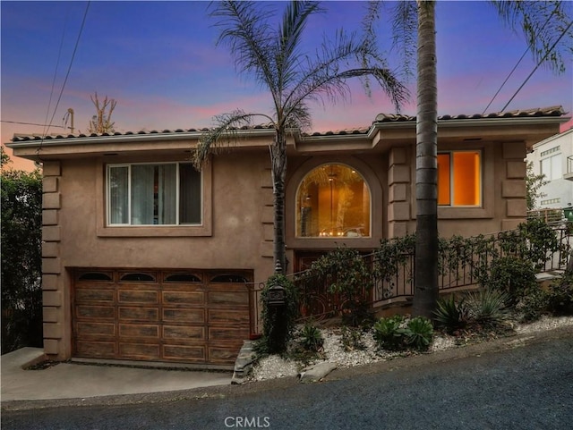 mediterranean / spanish-style home featuring a garage