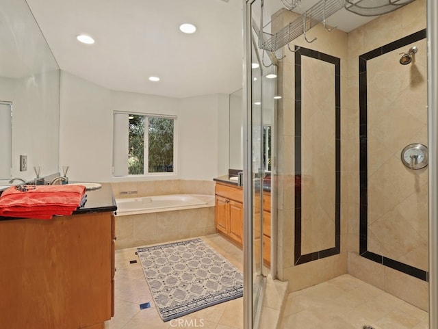 bathroom featuring separate shower and tub, vanity, and tile patterned floors