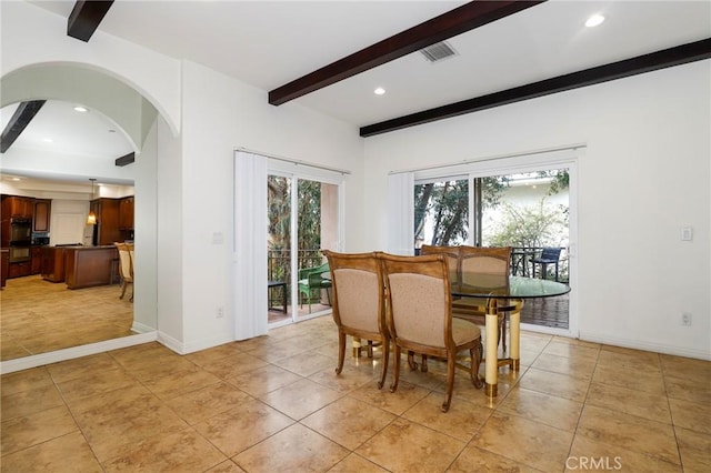 tiled dining area with beam ceiling