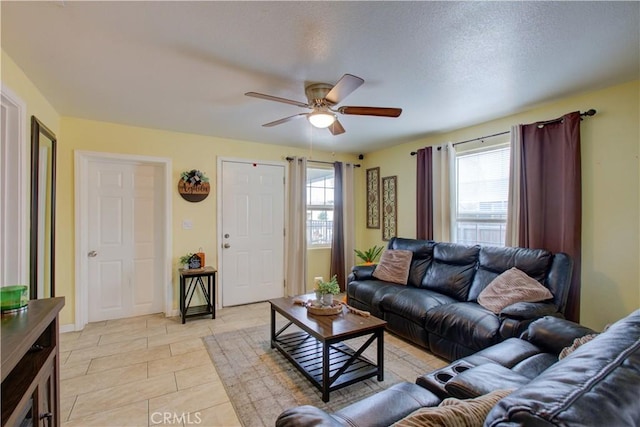 living room with ceiling fan, a healthy amount of sunlight, and light tile patterned floors