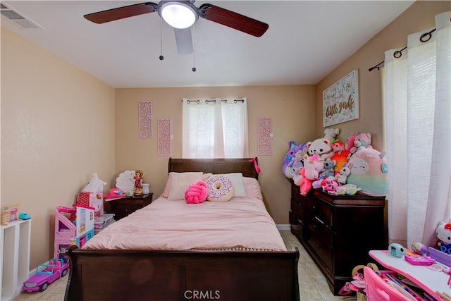 tiled bedroom with ceiling fan