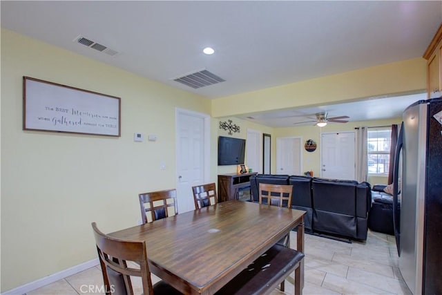 dining space with light tile patterned flooring and ceiling fan