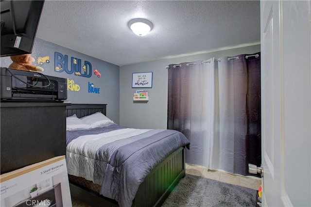 tiled bedroom featuring a textured ceiling