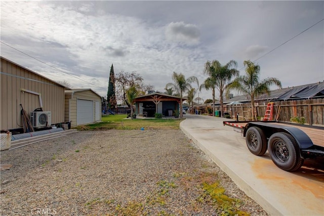 view of yard featuring a garage, an outdoor structure, and ac unit