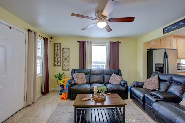 living room featuring light tile patterned floors, a wealth of natural light, and ceiling fan