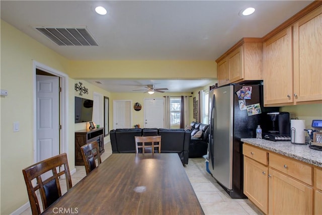 tiled dining space with ceiling fan