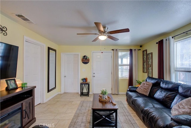 living room featuring light tile patterned flooring and ceiling fan