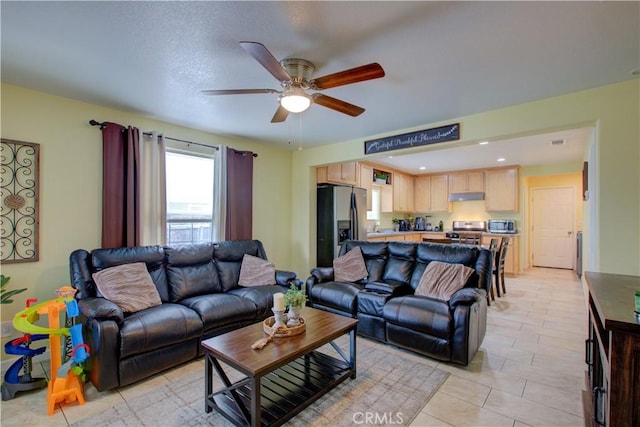 living room featuring light tile patterned floors and ceiling fan