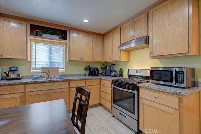 kitchen featuring stainless steel appliances, light stone countertops, sink, and light brown cabinets