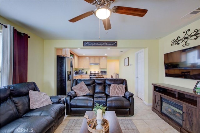 living room featuring ceiling fan and light tile patterned floors