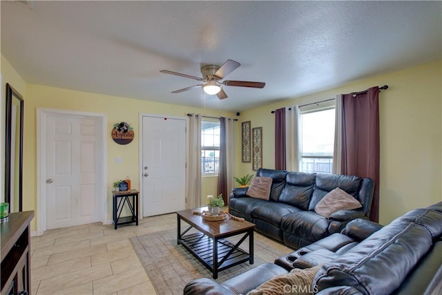 living room with light tile patterned flooring and ceiling fan