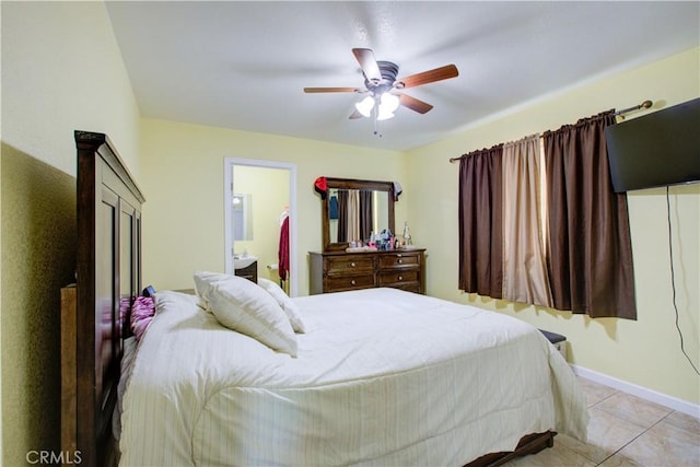 bedroom with light tile patterned flooring, connected bathroom, and ceiling fan