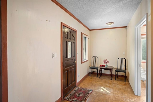 interior space featuring ornamental molding, a textured ceiling, and light parquet floors