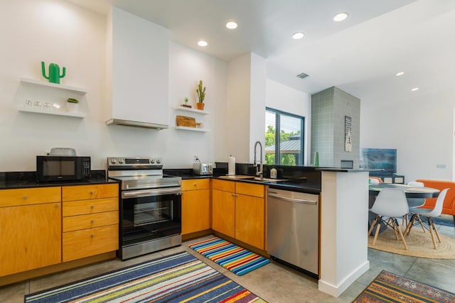 kitchen featuring tasteful backsplash, appliances with stainless steel finishes, sink, and concrete floors